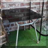 F75. Glass top side table.